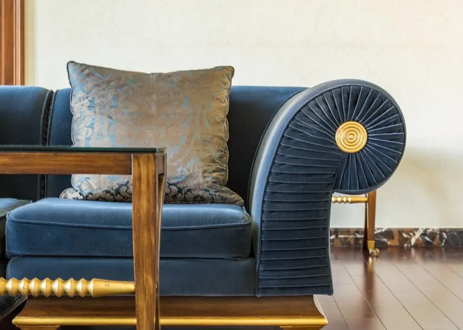 Interior of lounge with cozy sofa decorated with pillow with pattern in daylight
